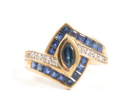 A sapphire and diamond ring, a marquise cut sapphire collet set in a yellow and white metal crossover design mount ring size 