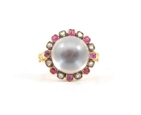 A moonstone, ruby and diamond ring, a 14mm round cabochon cut moonstone set in a yellow metal closed back mount and surrounde