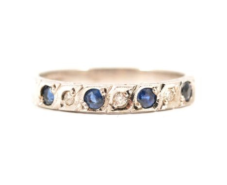 A sapphire and diamond half eternity ring, four round faceted sapphires and three brilliant cut diamonds pip claw set in a 9 