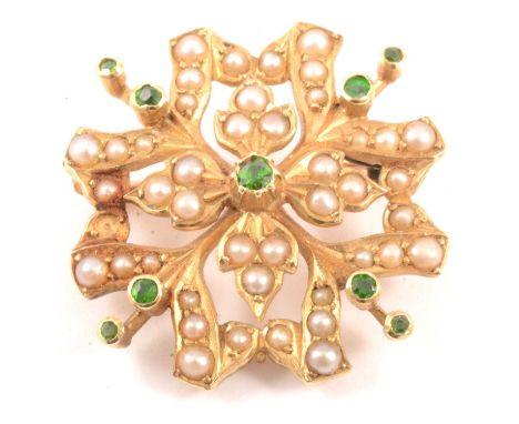 A seed pearl brooch set with nine bright green stones in a 30mm yellow metal closed back mount marked 15ct, gross weight 7.3g