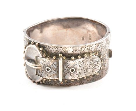 A Victorian silver half hinged bangle, buckle design on an ivy leaf background to front, Birmingham 1883, 30mm wide, internal