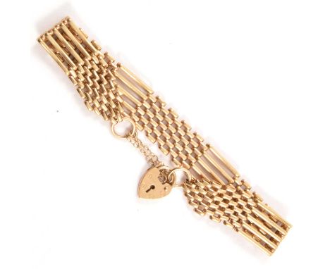 A 9 carat yellow gold five bar gate link bracelet, 10mm wide, fitted with a padlock fastener, 12.6g.Condition report:Length -