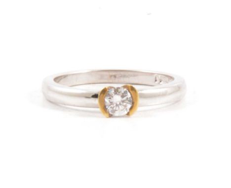 A diamond solitaire ring, the brilliant cut stone claw set in an 18 carat yellow and white gold mount ring size M, the diamon