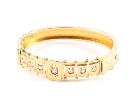 A Victorian diamond set half hinged bangle, the seven old cushion cut diamonds individually set in square mounts to an all ye