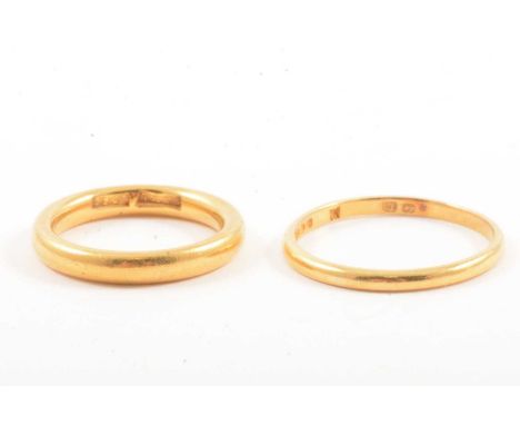 Two gold wedding rings, a 22 carat yellow gold wedding band, 1.8mm wide plain polished D shape ring size Q, (appears to be tw