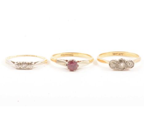 Two vintage diamond three stone rings and a ruby solitaire ring, a diamond three stone ring, the old cut stones illusion set 