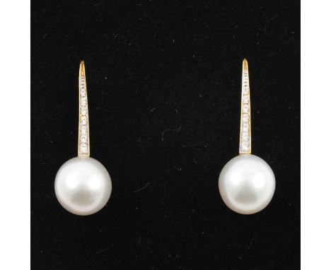 A pair of pearl and diamond earrings, a 10.5mm cultured pearl peg set to the base of a 20mm yellow metal bar set with seven b