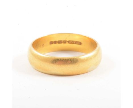 A 22 carat yellow gold wedding band, 5.5mm wide plain polished D shape ring size P, Birmingham 1970, 6.8g.