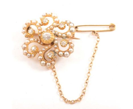 A diamond and seed pearl brooch, the central Old European cut diamond collet set surrounded by six swirl arms each pip set wi