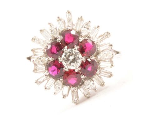 A ruby and diamond cluster ring, six circular faceted 3.8mm rubies, surrounding a central brilliant cut 4.2mm diamond, six ma