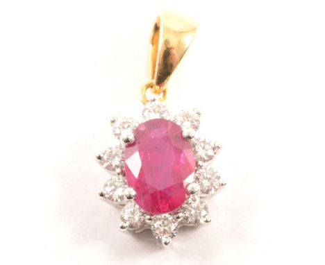 A ruby and diamond oval cluster pendant, the oval mixed cut ruby 7x5mm, four claw set and surrounded by ten brilliant cut dia