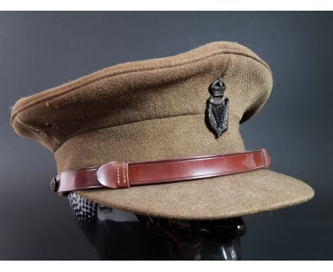 ANTIQUE BRITISH ARMY OFFICERS PEAKED CAP AND ROYAL IRISH CONSTABULARY CAP BADGE