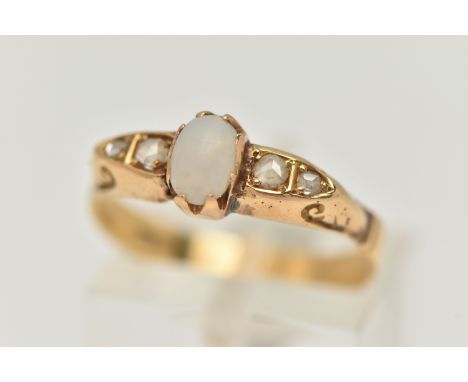 A YELLOW METAL OPAL AND DIAMOND RING, set with a central oval cut opal cabochon (abraded), measuring approximately 6.5mm x 4.