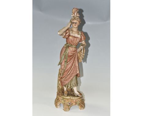 A ROYAL DUX PORCELAIN FIGURE OF A YOUNG WOMAN WITH SPECTACLES/LORGNETTES, applied pink Royal Dux triangle plaque on the base,