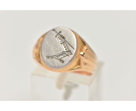 AN 18CT GOLD BI COLOUR SIGNET RING, designed as a white gold oval face with etched crest, depicting an arm holding a dagger, 