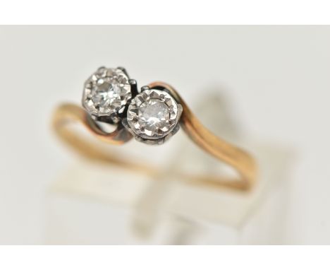 AN 18CT GOLD DIAMOND TWO STONE RING, cross over ring, set with two round brilliant cut diamonds, each illusion set, estimated