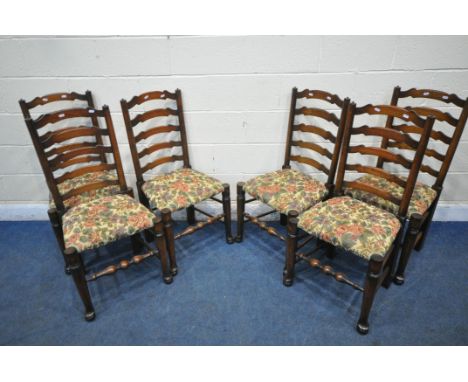 A SET OF SIX OAK LADDER BACK CHAIRS, with beige and floral upholstery, on turned legs and stretchers (condition report: overa
