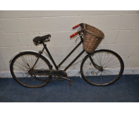 A VINTAGE RALEIGH LADIES BIKE (IDEAL FOR RESTORATION) with basket to front and a distressed leather Brooks seat, 21in frame