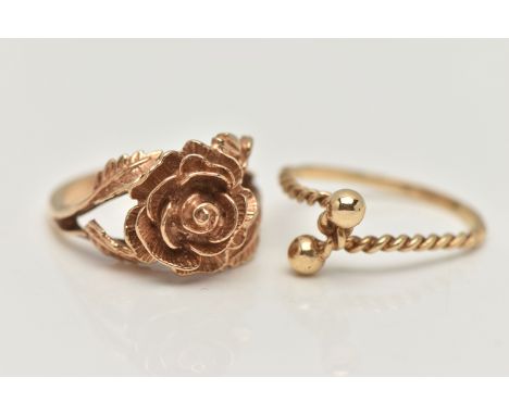 TWO YELLOW METAL RINGS, the first in the form of a textured rose, bifurcated shoulders leading onto a polished band, unmarked