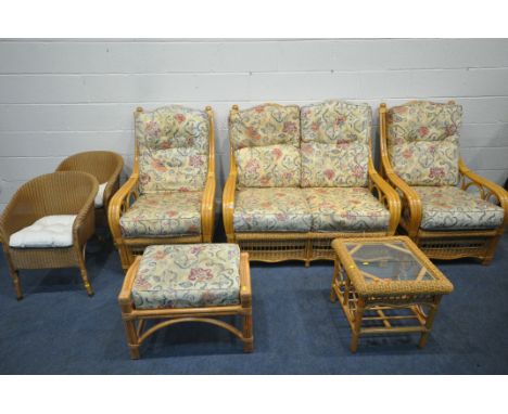 A RATTAN FIVE PIECE CONSERVATORY SUITE, comprising a two seater sofa, a pair of armchairs, a footstool, and a glass top side 