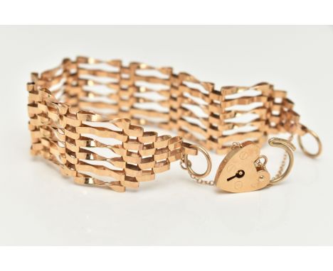 A 9CT GOLD GATE BRACELET, six bar bracelet, approximate width 19.5mm, fitted with a heart padlock clasp, hallmarked 9ct Londo