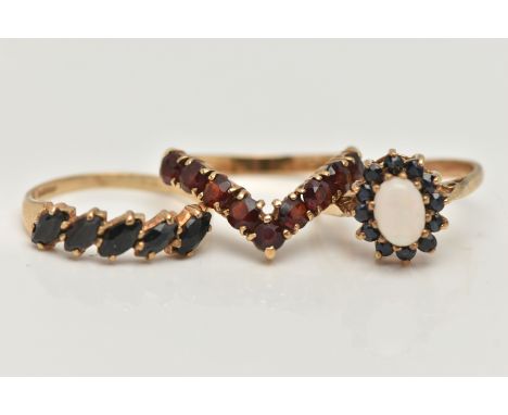 THREE 9CT GOLD GEM SET RINGS, the first a garnet nine stone wishbone ring, hallmarked 9ct Birmingham, ring size N, a half ete