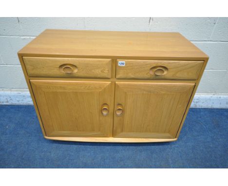 AN ERCOL WINDSOR ELM AND BEECH CABINET, fitted with two drawers, above two cupboard doors, width 92cm x depth 46cm x height 6