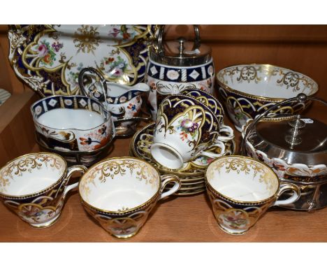 A GROUP OF TEA WARE, comprising a hand painted part tea set: a cake plate, a slop bowl, five teacups in two different sizes (