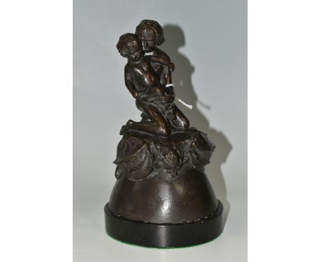 A BRONZE FIGURE GROUP, depicting a mother and child kneeling on top of a mythical beast, loose on a circular wooden base, uns
