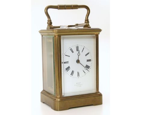 A brass framed carriage clock with white enamel face and Roman numerals. Bearing the retailers mark 'Dent 13, Cockspurs Londo