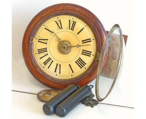 Postman's wall clock. With two brass weights and alarm striking on single bell. 14in diameter. Unfortunately we are not doing