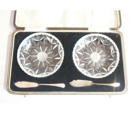 Cased set of 2 cut glass butter dishes and silver butter knives