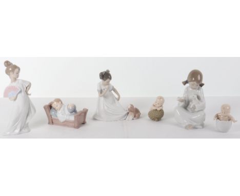 Ten Nao porcelain figures, including girl and lamb, baby in cot, girl and dog, mother and child, girl in dress, praying boy, 