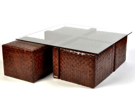 A 'Quadro' coffee table with four pouffe stools, wood and laminated leather, the table with glass top, 112 x 44.5cms (44 x 17