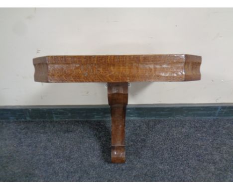 An Edwardian oak clock bracket 