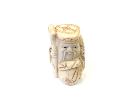 A Japanese carved bone netsuke - Village elder with a sack at his feet. 