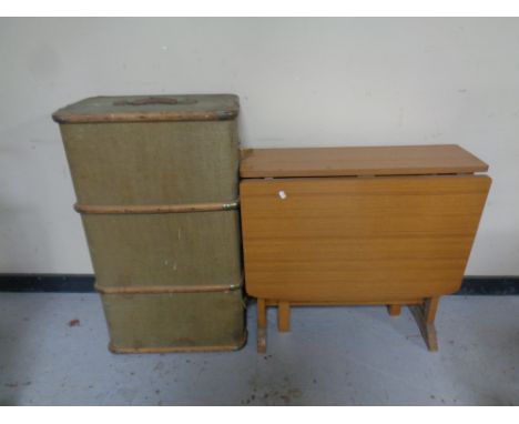 A teak melamine drop leaf table together with a bentwood bound trunk 
