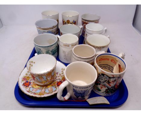 A tray containing a quantity of antique and later commemorative mugs, beakers and tankards to include enamel and china exampl
