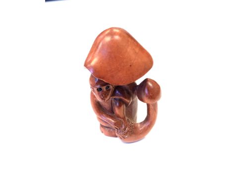 A Japanese carved fuitwood netsuke - A monkey under a toadstool. 