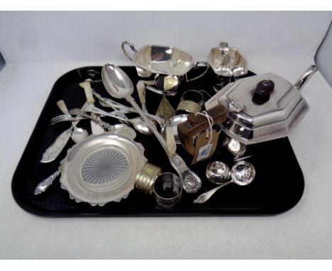 A collection of silver plated items to include three piece tea service, basting spoon, miniature trowel with mother of pearl 