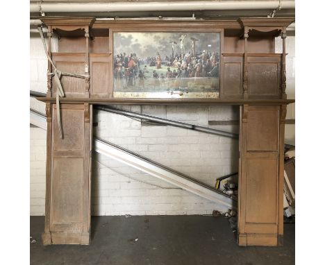 A late 19th century oak fire surround with central panel printed with colour print depicting Golgotha, total width 221 cm, to