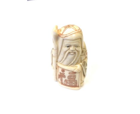 A Japanese carved bone netsuke - Village elder holding a scroll. 