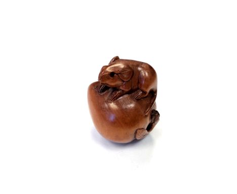 A Japanese carved fruitwood netsuke -  A rat on a pumpkin. 