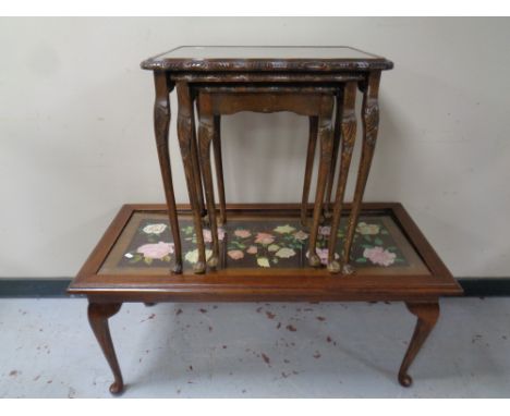 A mahogany coffee table on Queen Anne legs with a tapestry inset panel together with a nest of three mahogany glass topped ta