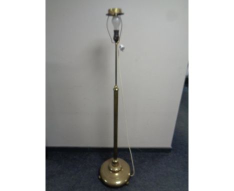 A 20th century heavy brass rise and fall standard lamp on circular base  