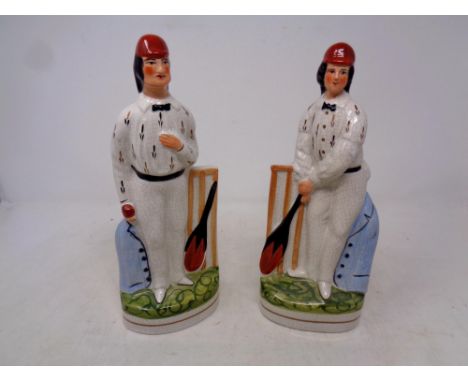 A pair of Staffordshire style cricketer figures together with a metal weather vane modelled as a cricketer 