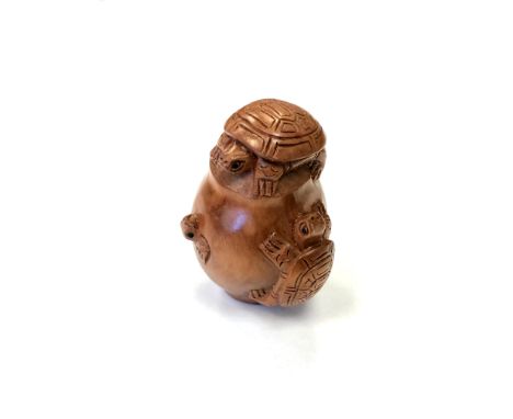 A Japanese carved fruitwood netsuke - Turtles on a barrel. 