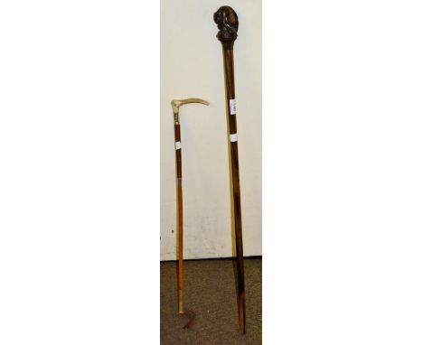 A carved tiger wood stick together with a silver mounted riding crop 