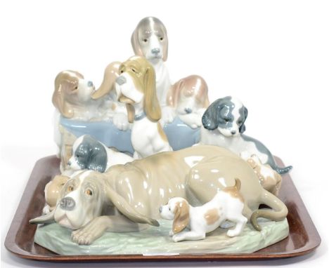 Lladro figure ''Pups in the Box'' no. 1121, a Nao figure of a Basset hound with pup and three other Nao pups (5) 