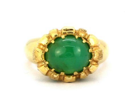 A heavy yellow metal (tested 18ct gold) ring set with a cabochon cut chrysoprase and emeralds, (R).